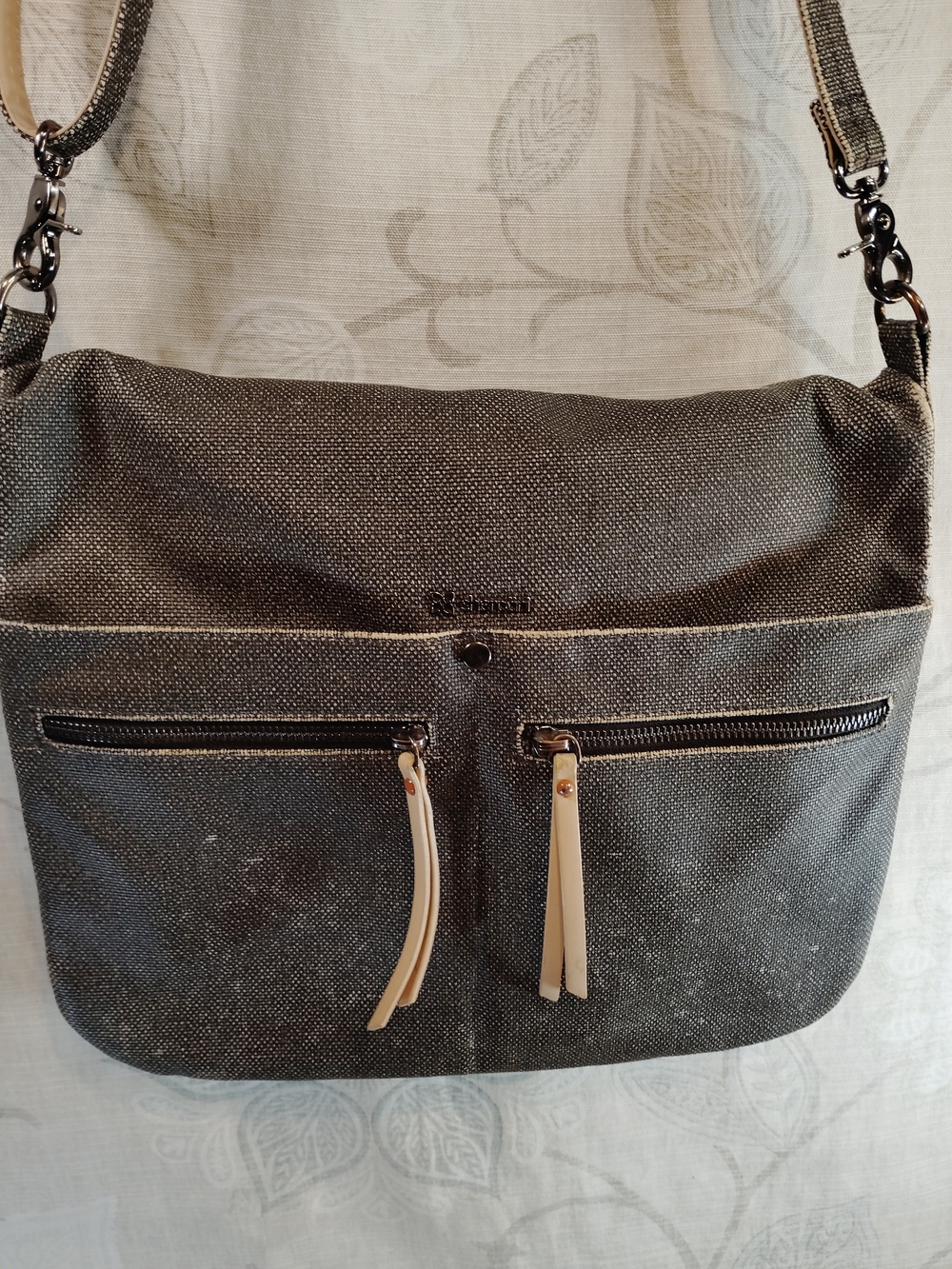 Sherpani charcoal crossbody bag with cream zipper pulls